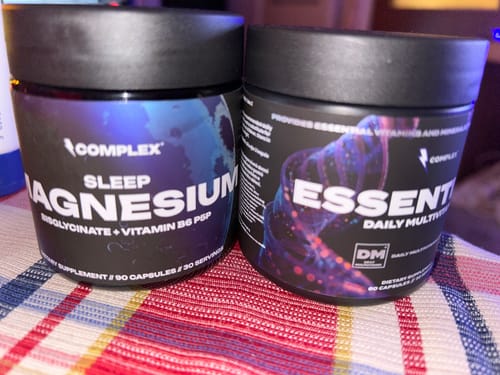 Reviewer's black jar of Complex Sleep Magnesium next to another Complex brand supplement.