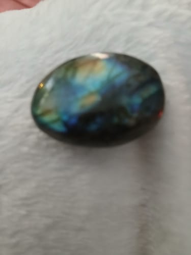 Close-up: Customer's polished labradorite crystal showing blue and green iridescence.