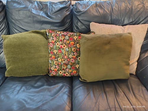 Customer's green cushions on a sofa, showing both sides of the Double Sided Velvet Chenille Fabric.