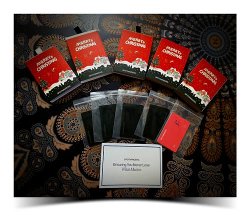 Customer's multiple SPOTMINDERS. Wireless Chargers laid out in festive Christmas boxes and clear protective sleeves.