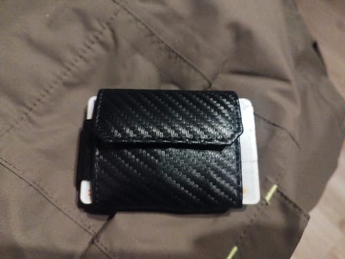 Customer's black Nano Boy Pocket card holder wallet with a carbon fiber texture, shown full with cards.