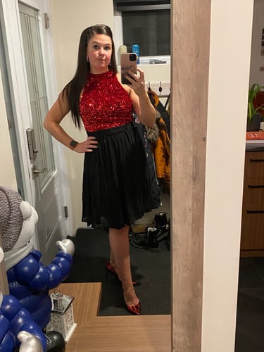 Customer takes a mirror selfie wearing the beautiful red glitter and black patchwork dress.