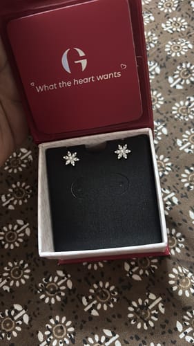 Customer's Silver Flowery Snowflake Studs displayed in their open red jewelry box.