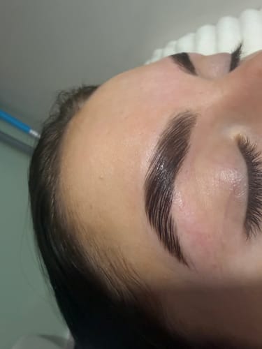 A reviewer's shiny, laminated eyebrows and lashes after a treatment with the Cysteamine lamination kit.