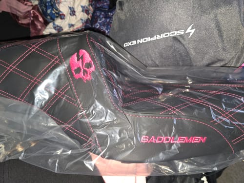 Customer's new black Saddlemen Step Up Seat with pink diamond stitching and an embroidered pink skull, still in its plastic packaging.