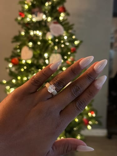 A reviewer's hand wearing the GlowStone Collection silicone ring with a large oval-cut stone.