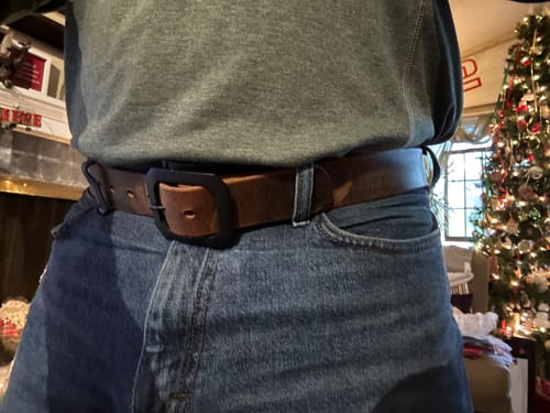Close-up of a reviewer wearing the brown Relic Retro Style belt with a matte black octagonal buckle.