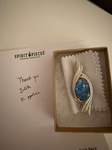 Reviewer's blue Madison Sterling Silver Wire Wrapped Pendant resting in its gift box next to a handwritten thank you note.