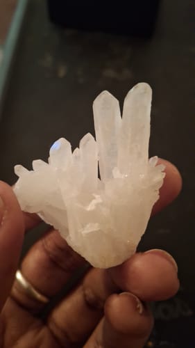 Customer holding a beautiful clear quartz crystal cluster from their VIP Crystal Club.