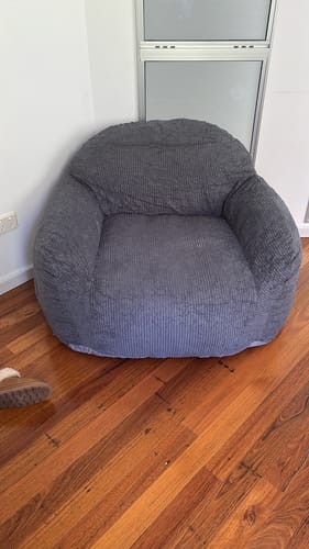 Customer's plush, grey Luxury Foam Relax Chair on a wooden floor.
