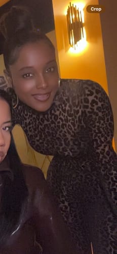Close-up of a reviewer smiling while wearing the leopard print Burnout Print Turtleneck Bodysuit.