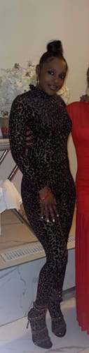 Reviewer wearing the leopard print Burnout Print Turtleneck Bodysuit and matching leggings as a complete stylish outfit.