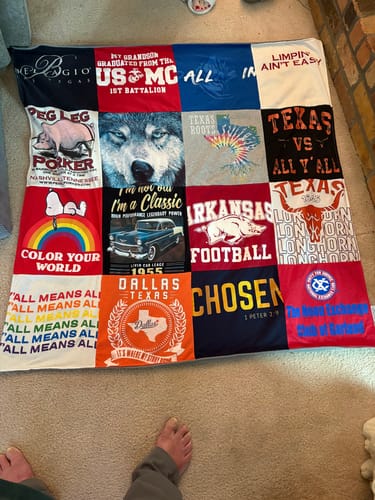 Customer's colorful Premium T Shirt Quilt laid out on a floor, showing a variety of personalized t-shirt squares.