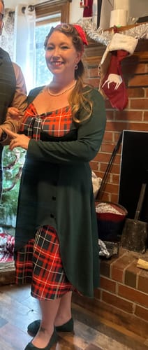 Customer wearing the long-sleeved Green & Red Plaid Patchwork Dress, showing the sweetheart neckline and split plaid skirt.