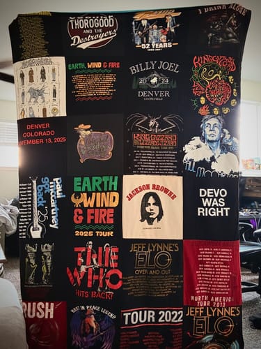 Customer's blanket made from many black concert t-shirts for bands like The Who, Rush, and Billy Joel.