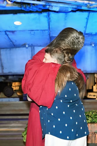 Reviewer wearing the blue Star Wars™ "12 Parsecs" shirt while being hugged by the character Chewbacca.