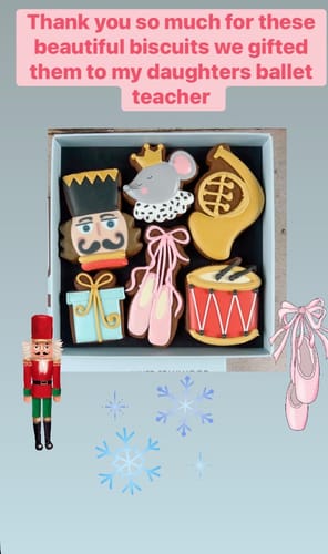Reviewer's Nutcracker Biscuit Box with decorated biscuits of the Nutcracker, Mouse King, and ballet shoes.