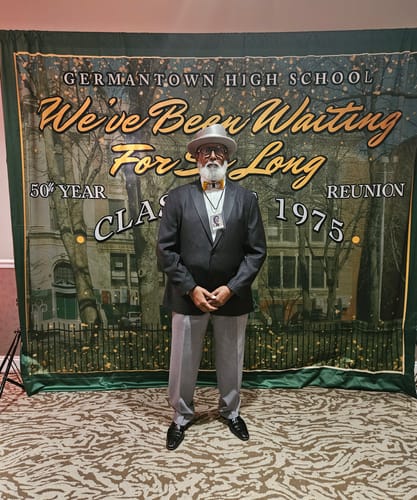 Reviewer wearing the Turkey Feather Bow Tie with a dark suit at their 50th high school reunion.