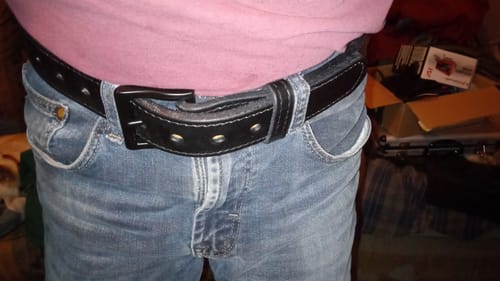Customer wearing the thick, rugged Black Out Tactical belt with a pair of blue jeans.