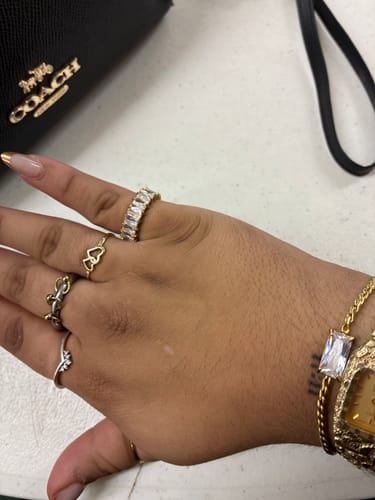 Customer's hand wearing several rings and a bracelet from the WaterProof Jewelry Bundle.