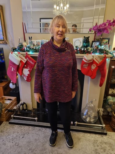 Customer wearing the Phila Wine Zip Collar Tunic, showing the diamond pattern and roll neck detail.