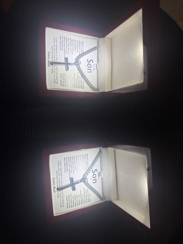 Customer's photo of two Artisan Cross on Cuban Link Chain gift sets in their open, illuminated boxes with message cards.