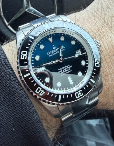 Customer's close-up of the Oceaneva Pro Diver Watch on their wrist, showing the blue and black dial and stainless steel band.