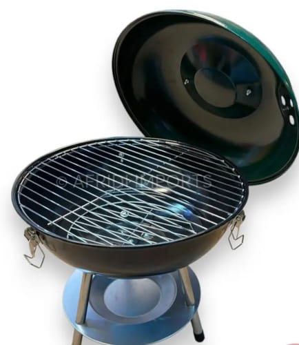Customer's black 14-inch tabletop charcoal grill with its lid open, showing the cooking grate.