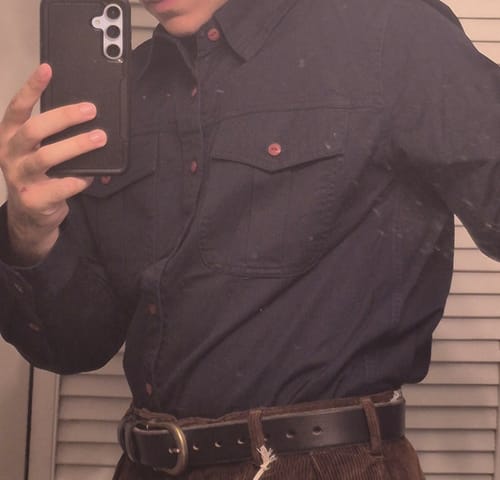 Close-up of a reviewer wearing the navy Classic Fit Engineer Workshirt, showing the relaxed fit while tucked in.