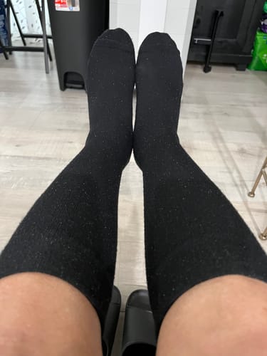 Reviewer's point of view wearing the black Performance Eucalyptus Compression Socks, showing the knee-high fit.