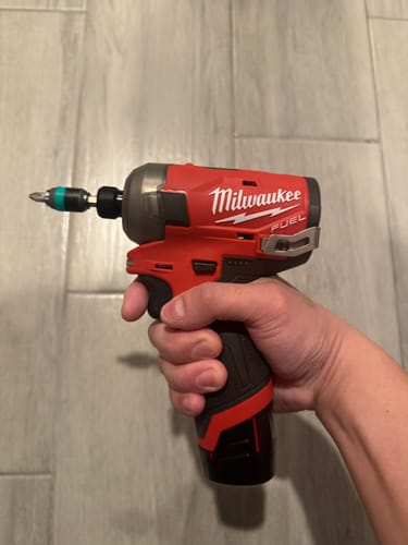 Reviewer holding a power tool, showing the Wera Rapidaptor Universal Bit Holder with a bit attached.