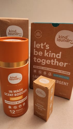 Customer's collection of Kind Laundry products, including the orange Wash N' Boost Scent Booster.