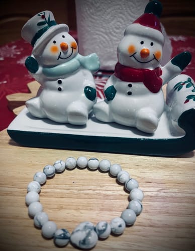 Customer's lovely howlite bracelet from their VIP Crystal Club subscription on a table with festive snowman decorations.