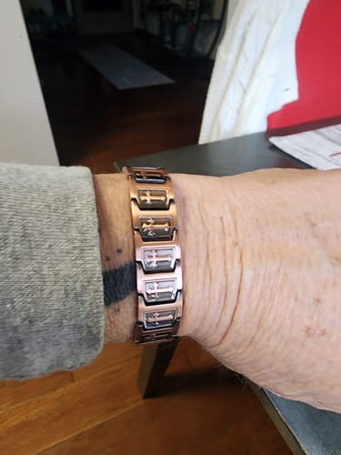 Reviewer wearing the Templar Cross Copper Magnetic Bracelet on their wrist, showing the detailed cross design on the links.