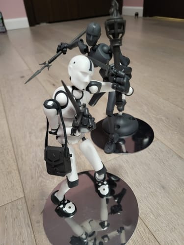 Reviewer's white and grey figures posed with Stickybones Magna-Props including a dagger, spear, torch, and coin pouch.