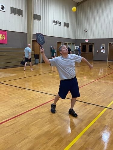 Reviewer playing an energetic game of pickleball after getting relief from aches and sprains with Super Strong Relief.