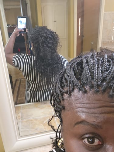 Reviewer's mirror selfie showing microbraids and the back of their long, Wet & Wavy Bulk Hair Extensions.