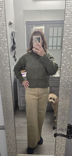 Reviewer showing the fit of the sand-colored Calla Denim Jeans with front seam detail.