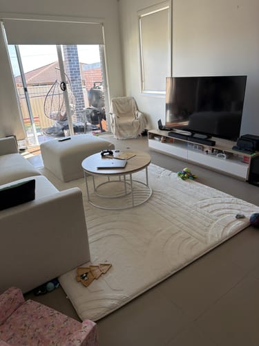 Customer's soft, cream Mellow Mat with a carved design in their living room.