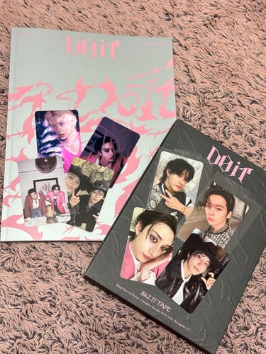 Reviewer displays two versions of the STRAY KIDS DO IT SKZ IT TAPE ALBUM with the collectible photocards they received.