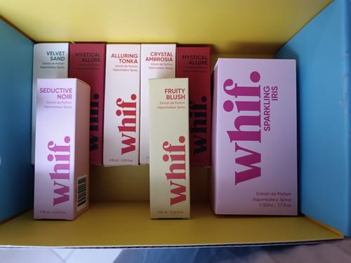 Reviewer's Fruity Blush perfume box standing with a collection of other scents inside a larger box.