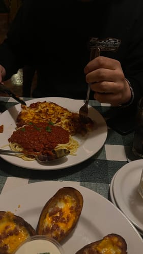 A customer's boyfriend wearing the 4mm Franco Link Bracelet on his wrist while at a dinner table.