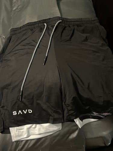 Customer's black Soldier’s Faith Performance Shorts laid flat, showing the white drawstrings and SAVD logo.