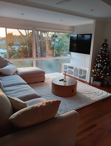 Customer's cream Mellow Mat with a carved pattern shown in a modern living room under a coffee table.