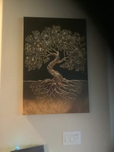 Reviewer's beautiful canvas print of a metallic tree hanging on their wall.