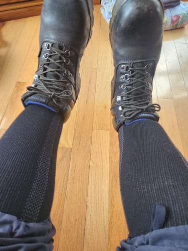 Reviewer wearing the black Men's Alpaca Socks pulled up to the calf with a pair of work boots.