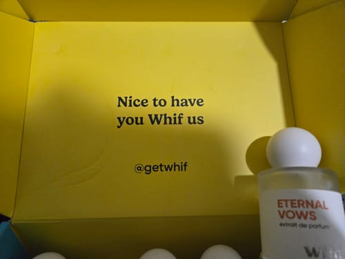 Customer's bottle of Eternal Vows perfume with a white cap, displayed inside a bright yellow brand box.