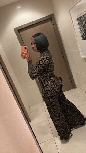 Customer's side view of the Burnout Wide-Leg Jumpsuit, showing the curve-hugging fit and wide legs.