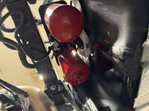 Close-up of the customer's red SPE Motorsport Fuel Filter System installed underneath a truck.
