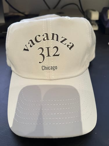 Customer's white Custom Performance Hat featuring a custom graphic that reads "vacanza 312 Chicago".